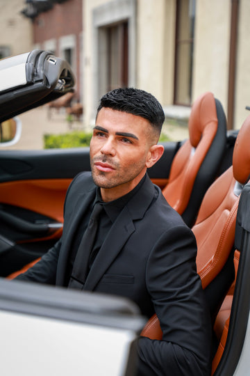 man posing in convertible sports car