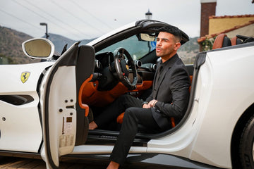 man posing in convertible sports car