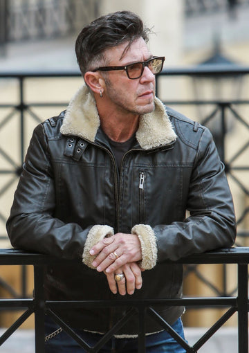 man with dark hair, leather jacket, and sunglasses