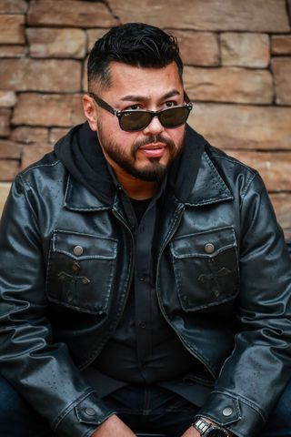 man with dark hair and sunglasses